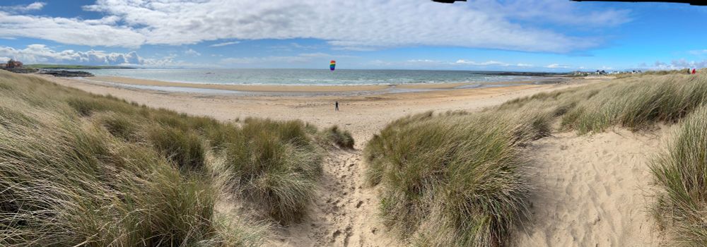Panoramic view, Rhosneigr (Traeth Llydan) Beach, Anglesey. Kite flying.