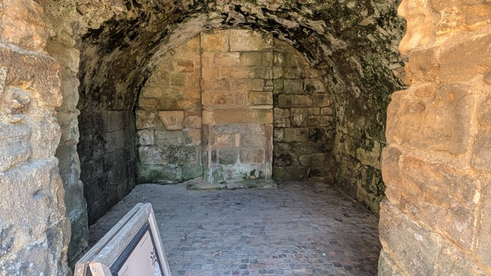 A view from a doorway of a small, arched stone room, only a few metres in size