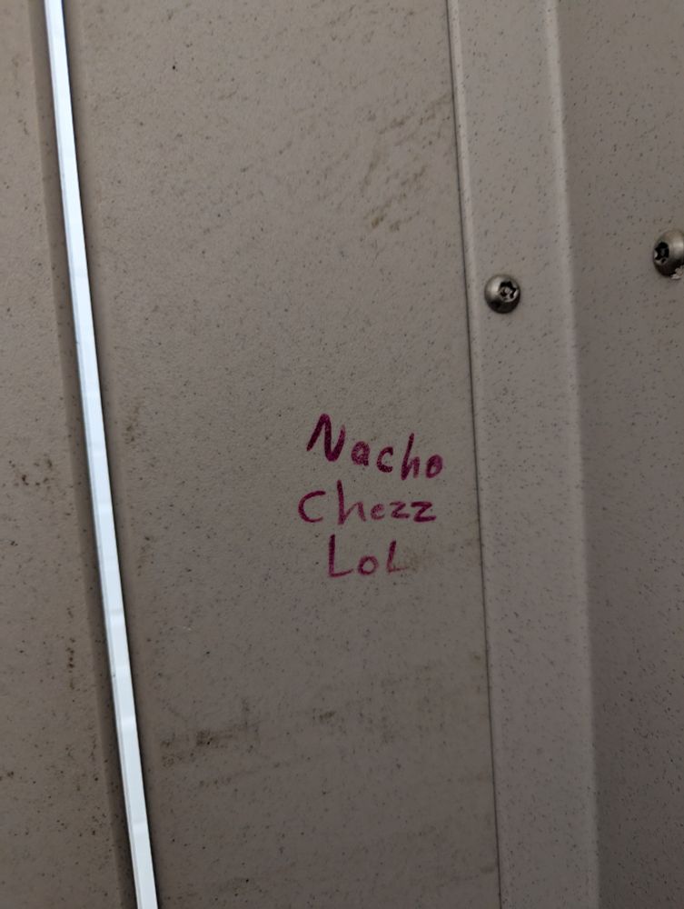 bathroom stall graffiti reading: Nacho chezz LoL