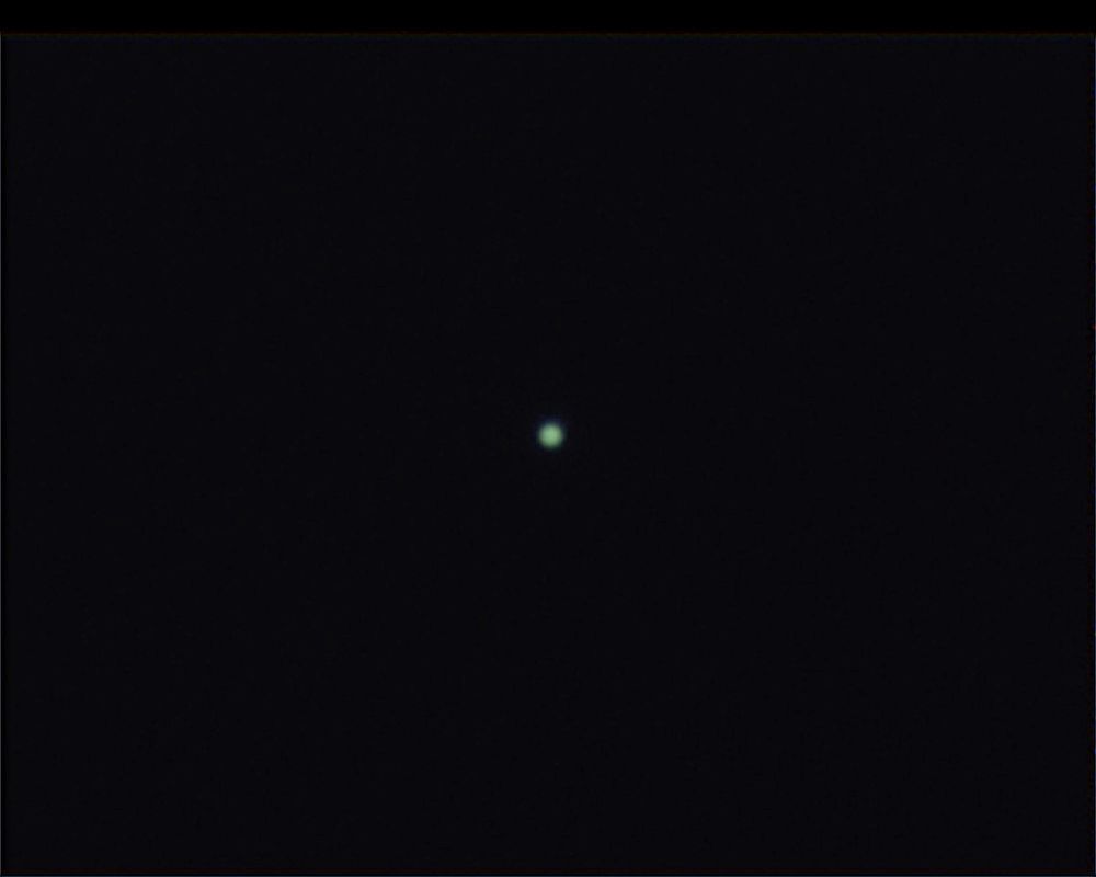 Small blueish planet against a black sky