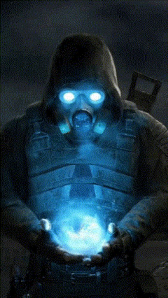 a man in a gas mask is holding a glowing object in his hands