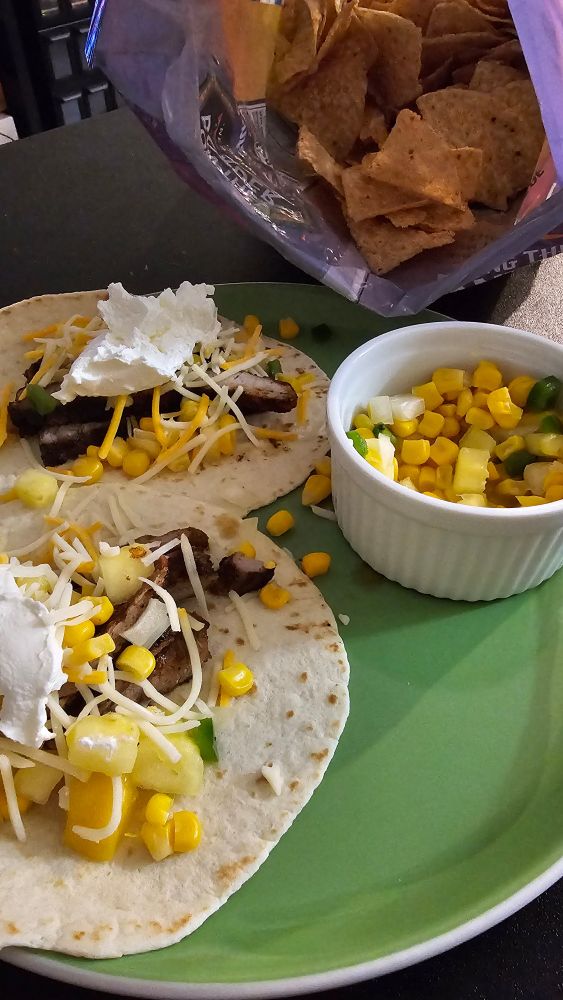 Pork tacos with a mango-pineapple salsa. 