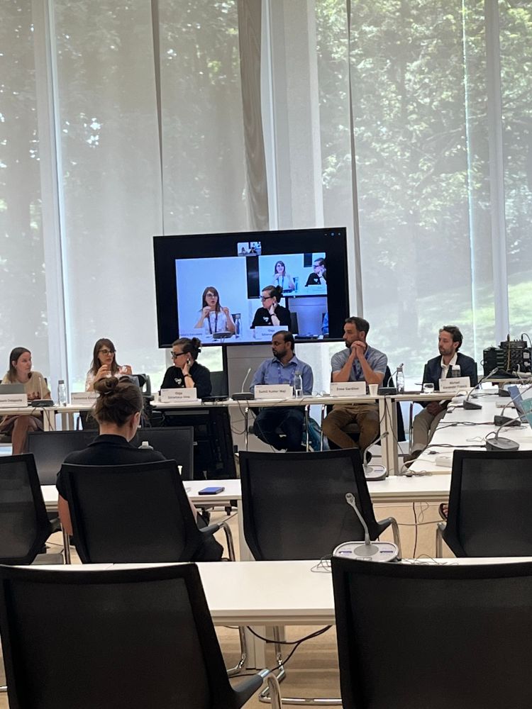 A panel presenting to a group of people
