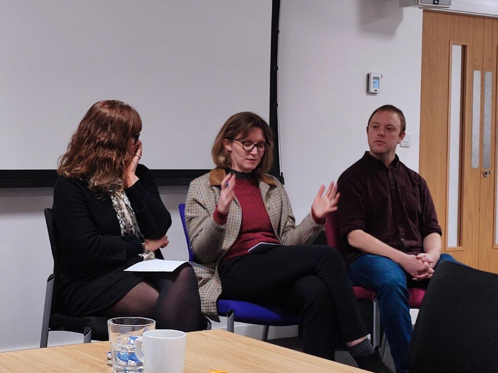 Three people sat on a panel discussing