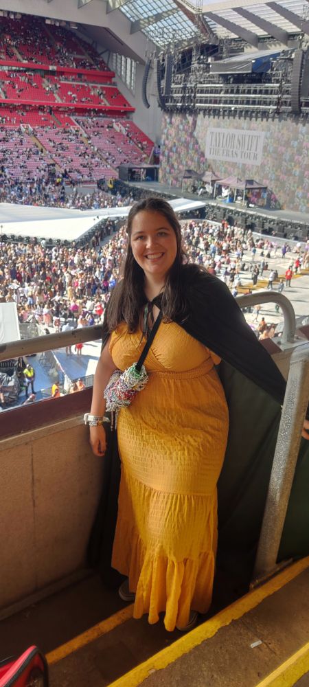 The same girl inside the stadium, picture taken from the stand with the stage in the background