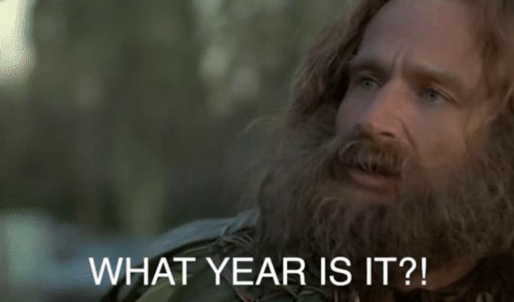 a man with long hair and a beard is asking what year is it