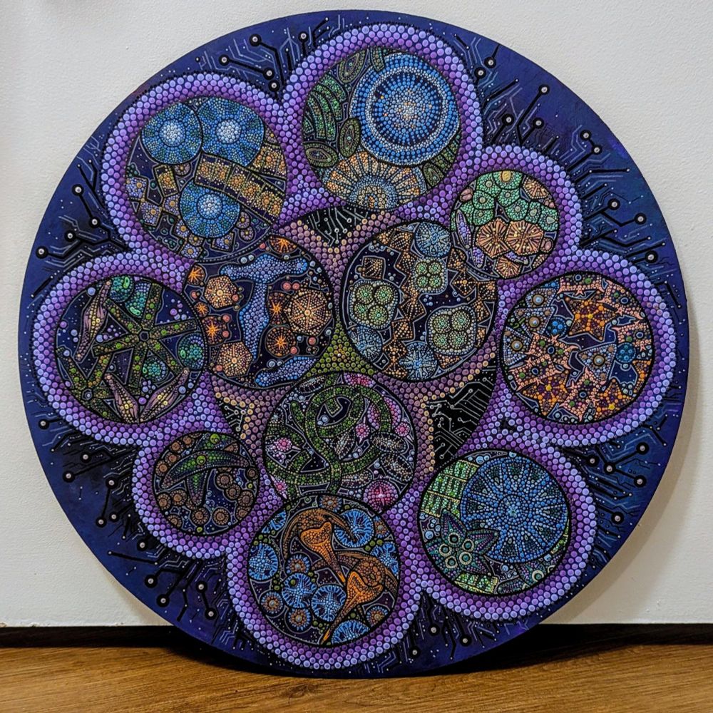 A circular 18-inch acrylic dot painting titled "Holobiont," composed of countless small, colorful dots arranged in intricate patterns, inspired by microbial diversity.