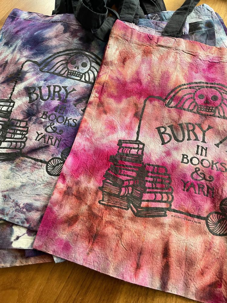 Ice dyed Bury Me in Books and Yarn tote bags illustrated and dyed by a human, Rita