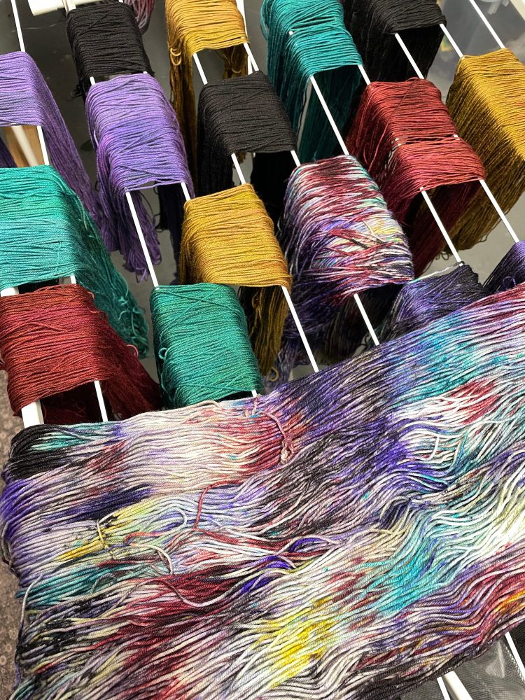 Yarn skeins and sets inspired by The Picture of Dorian Gray damp on a drying rack in a dark basement