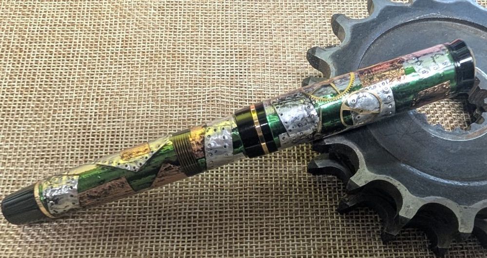 Steampunk patterned fountain pen with green ribbon