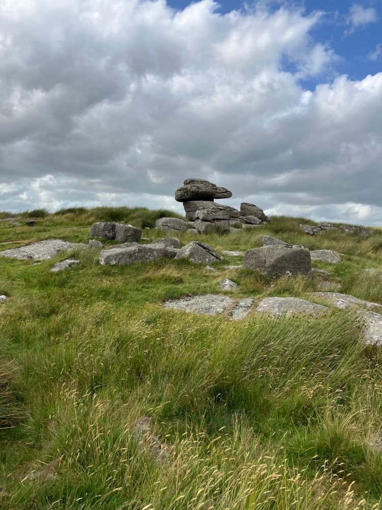 Logan stone beneath cloudy sky