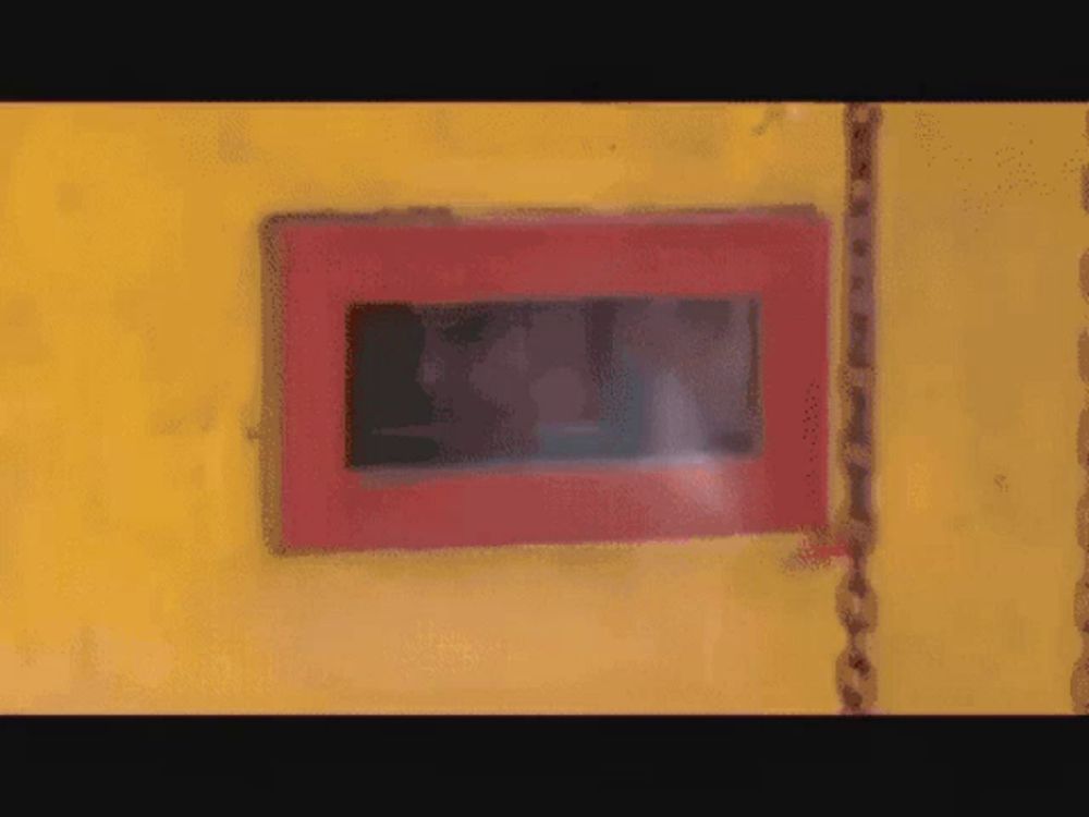 a red box on a yellow wall with the word exit on it