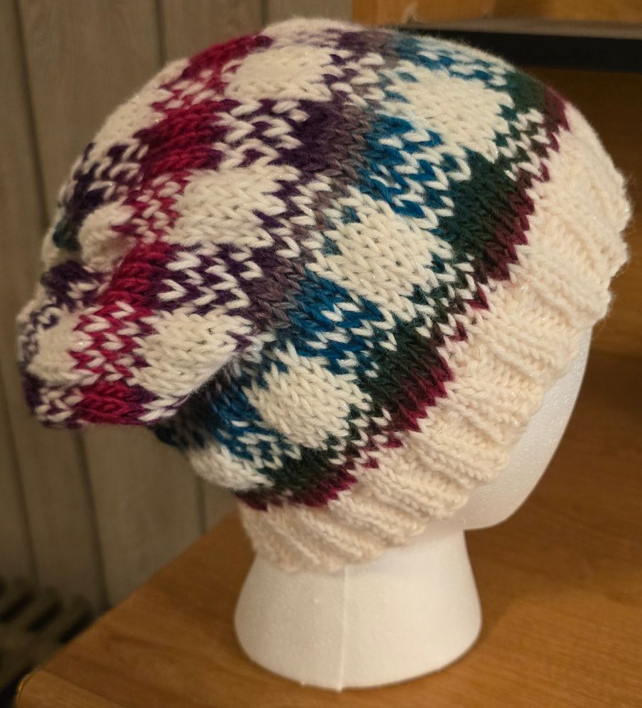 This is landscape yarn on sparkly white but you can't see the sparkles. A plaid fair isle pattern in purple and blue