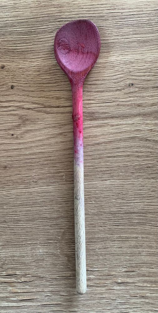 Ein lila verfärbter Holz Kochlöffel 