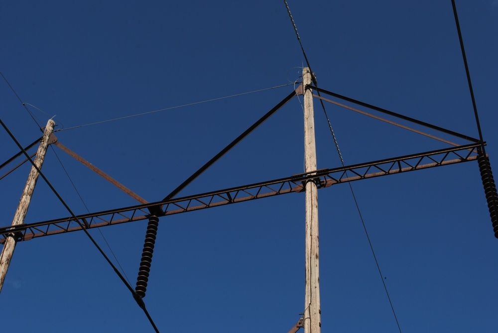 picture of powerlines with a clear blue sky in the background 
