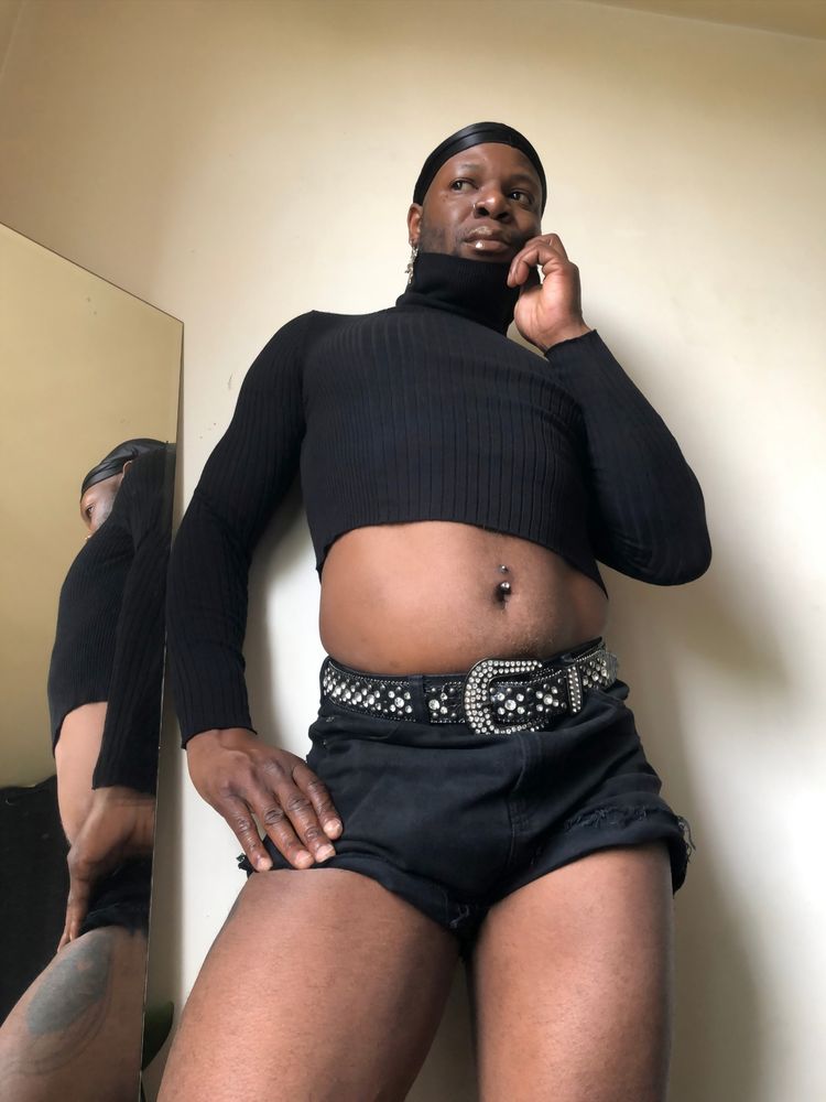 In this one I am facing forward, I am looking out the window, my right hand is holding my right thigh, my left hand is holding the collar of my sweater, I am wearing a cowboy-style rhinestone and sequin belt