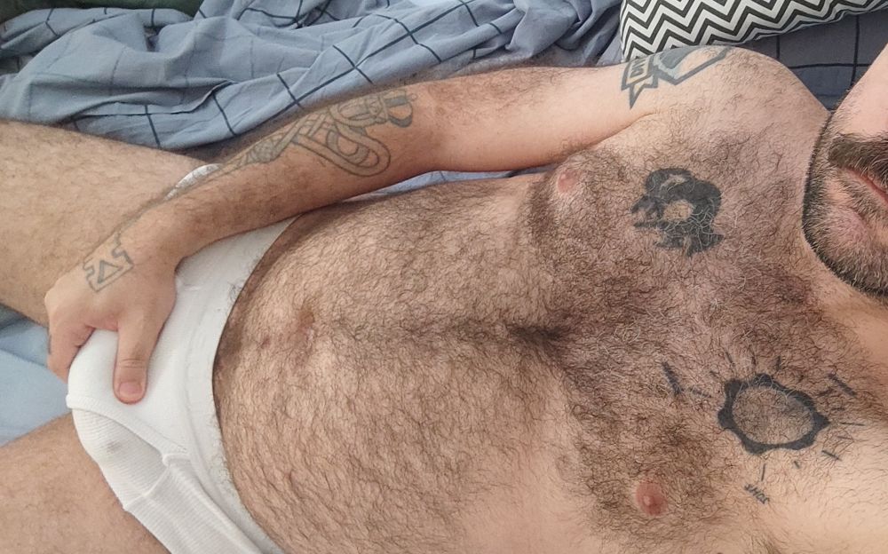 Me laying in bed wearing only white briefs