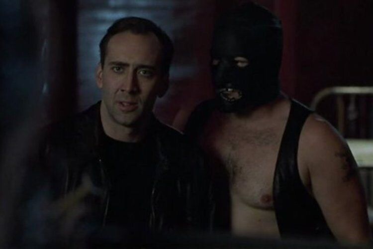 Nick Cage standing with Machine in the movie 8MM.