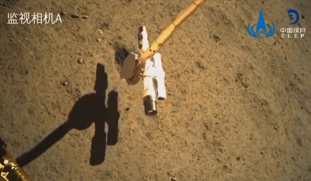 Image of Chang'e 6 robotic arm sampling soil in the lunar surface
