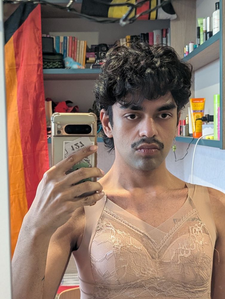 A non binary diva serving they/them with tits and a moustache 