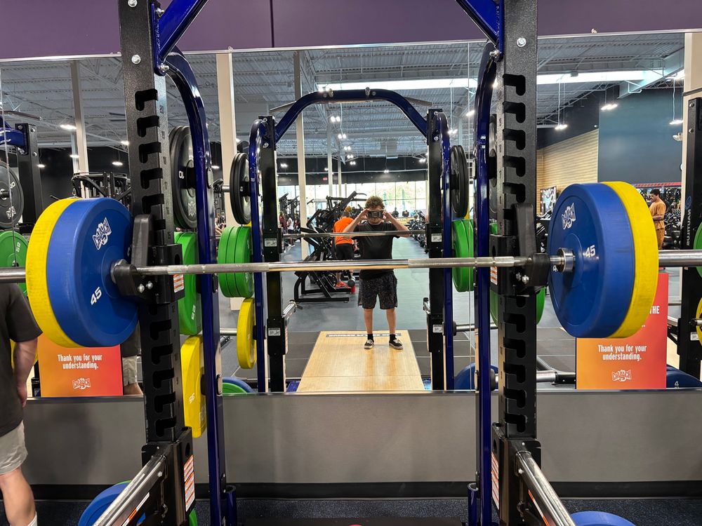 A squat rack with a barbell loaded to 205 (45 +35 on each side)