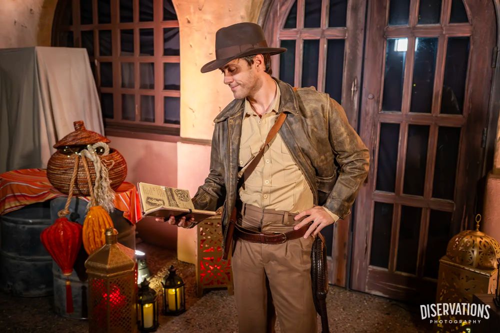 Indiana Jones reading a book. At a party...