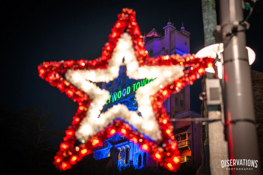Looking through a Christmas star decoration at the Tower of Terror marquee