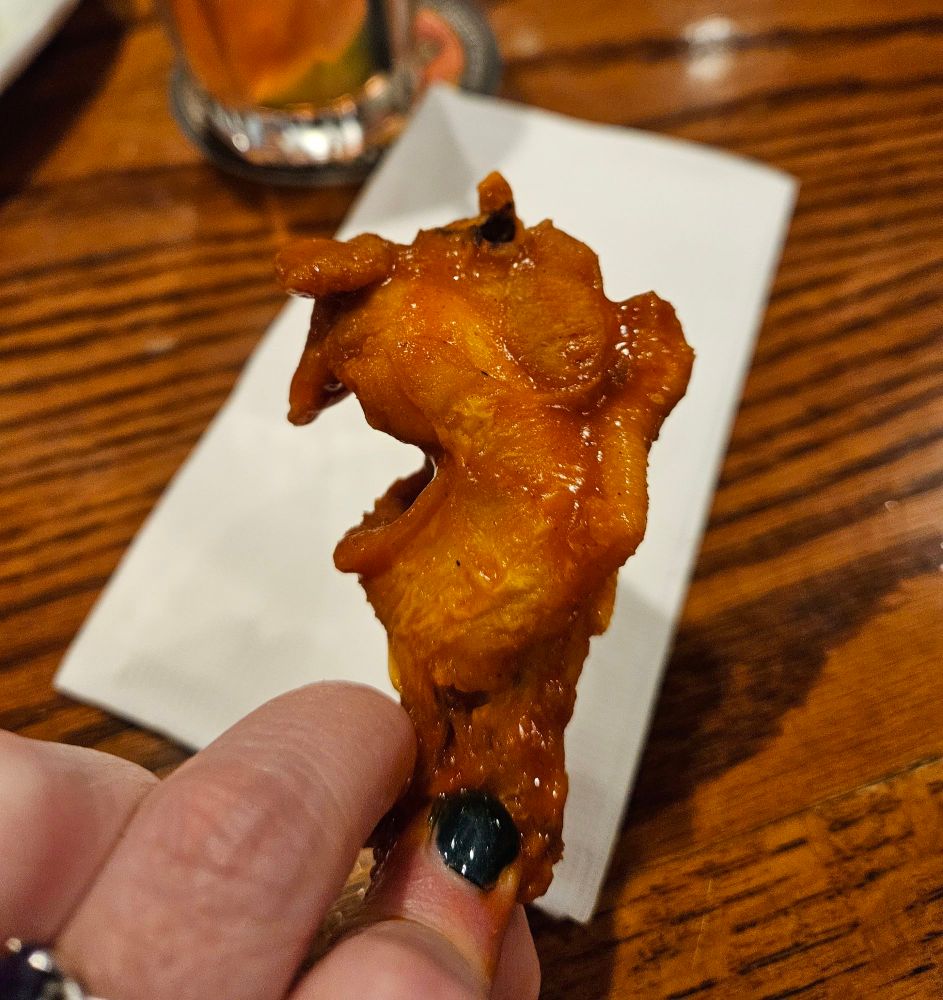 A buffalo chicken wing cut in the center, making it appear like a profile of an old man with his mouth open