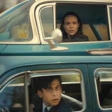 Vanya and Five from Umbrella Academy both being shocked seeing each other in cars as they drive past each other.