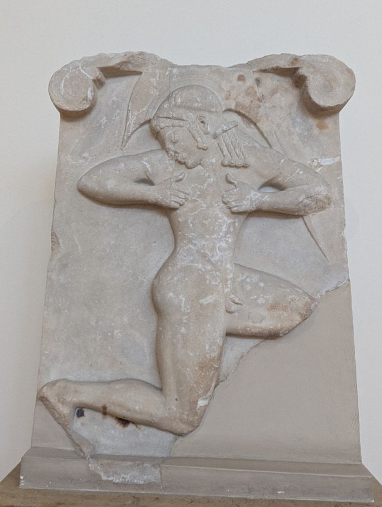 An ancient Greek relief that is as described in the text. It's a good butt.