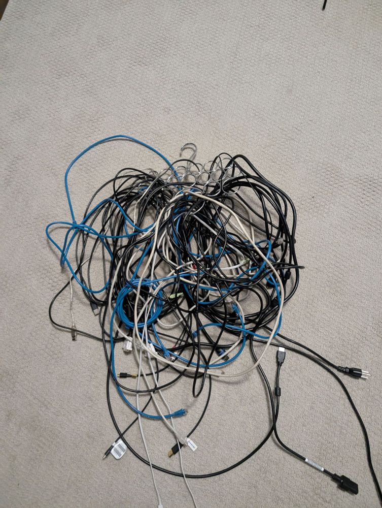 Jumbled mess of cables on a tie hanger