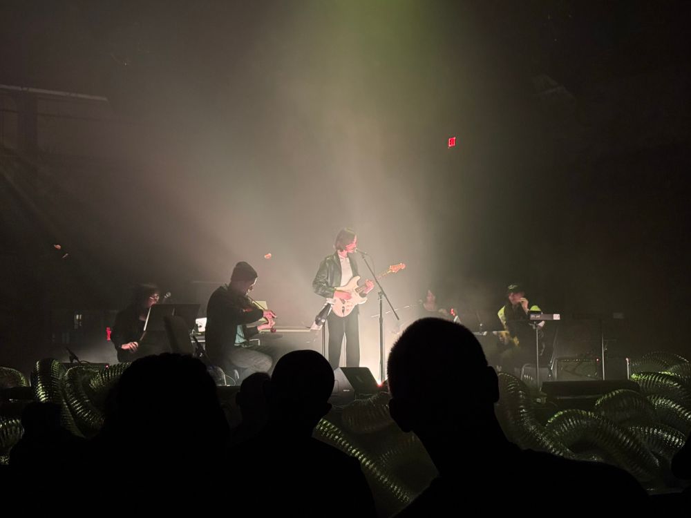 claire rousay playing guitar center stage lit in white.