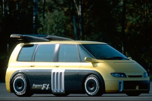 A black and gold Renault Espace people carrier with "Espace F1" on the side panel. It is styled to look like a race car with large tyres and a large wing on the roof.
