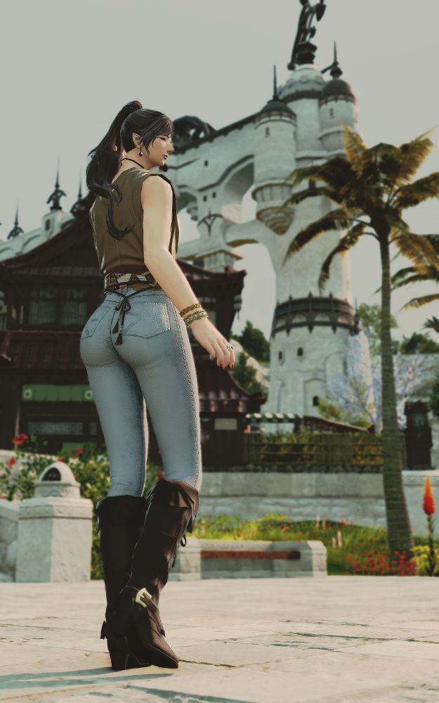 Leggy elezen in tight jeans , tan knee high boots and draped top , enjoying a beautiful sunny day 