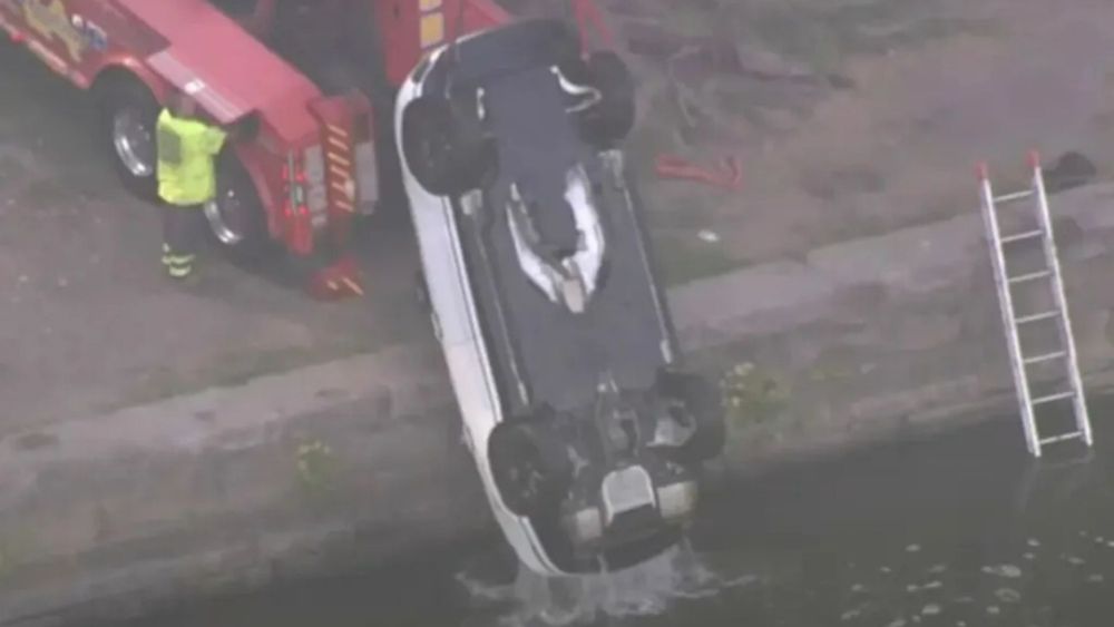 Raunchy couple flees car after it rolls into river while they romped in back