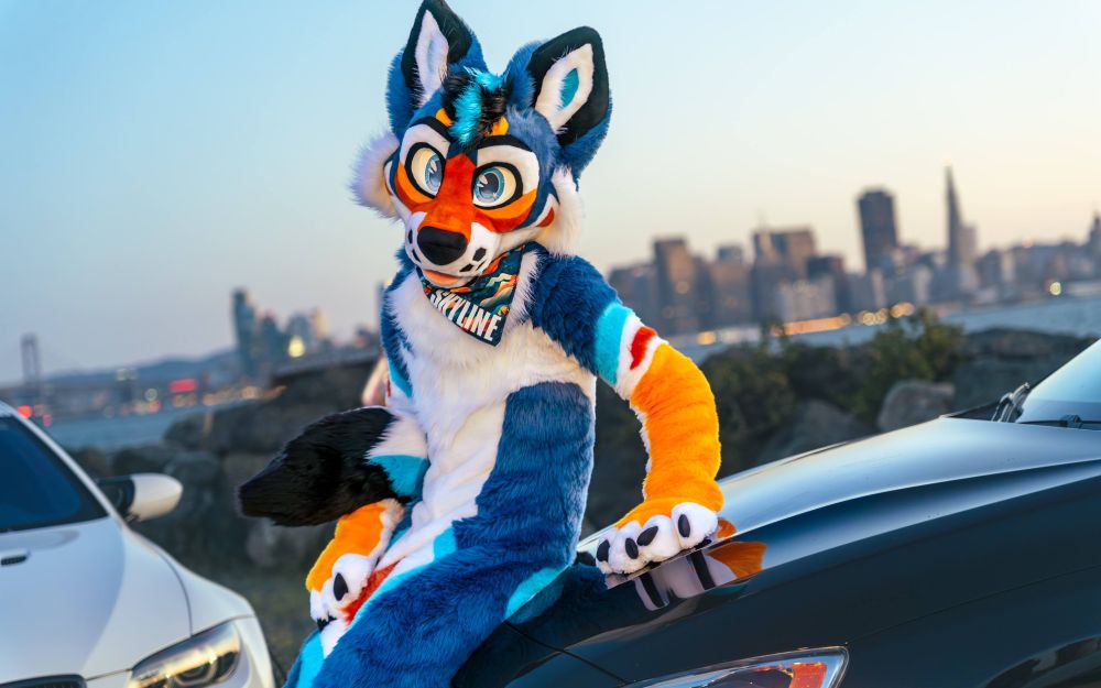 Skyline the blorange coyote in front of a city skyline