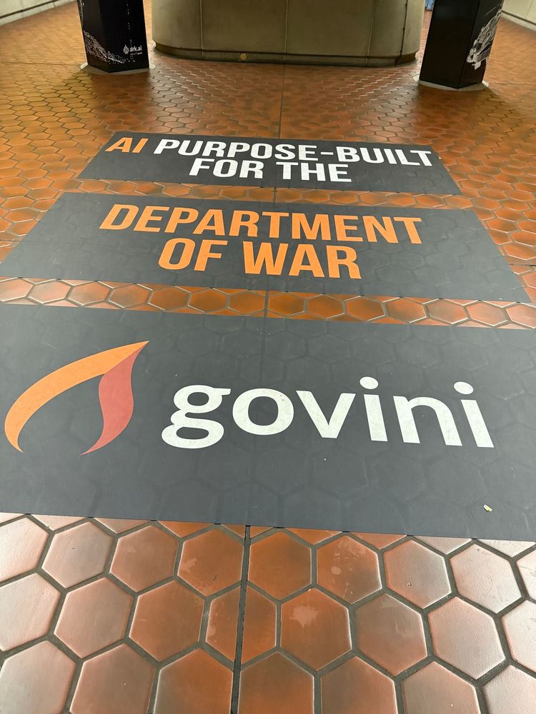 Floor advertising in the DC metro saying “AI PURPOSE-BUILT FOR THE DEPARTMENT OF WAR”