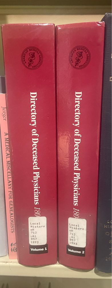 Spines of two red books titled Directory of Deceased Physicians