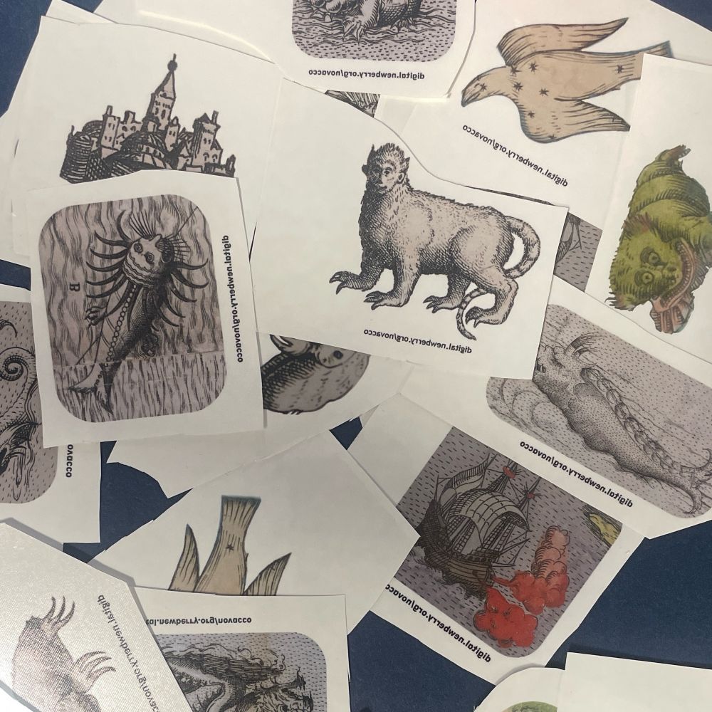 Pile of temporary tattoos of sea monsters and ships from old maps