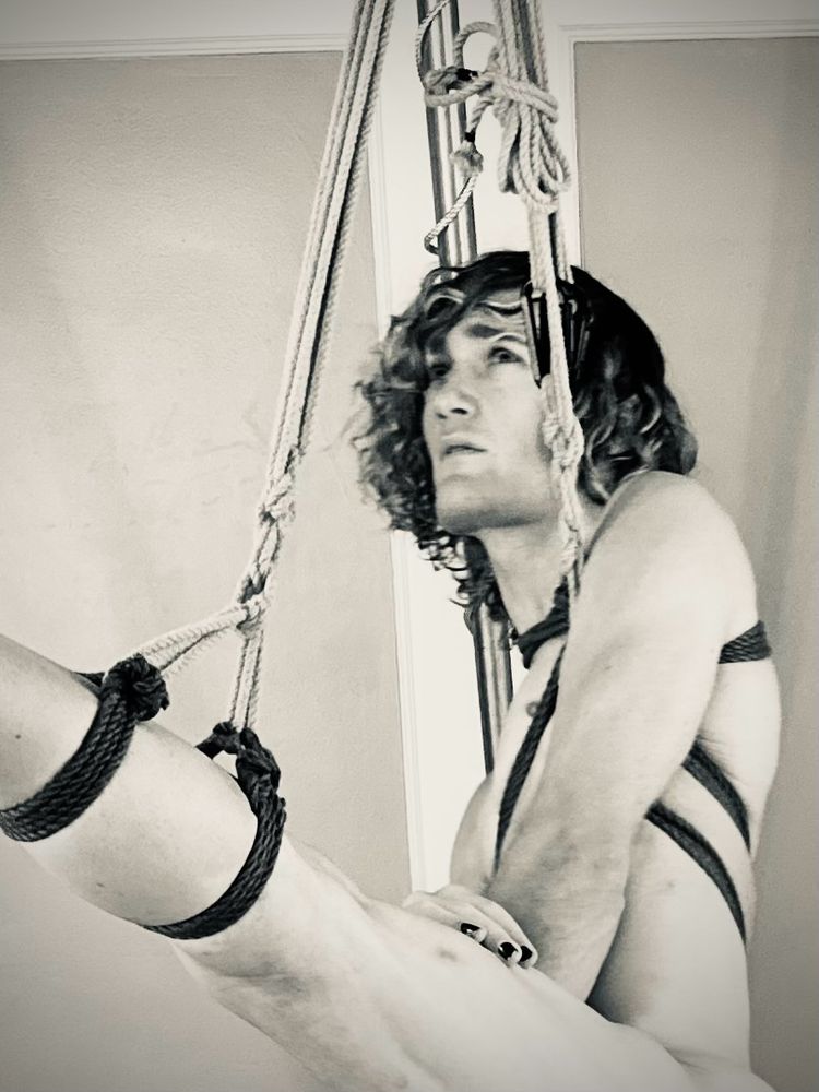 His thigh is cuffed with rope and lifted up. His eyes are lifted up. His spirits are lifted up. 