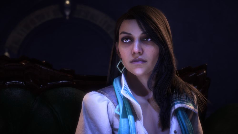 a screenshot of neve gallus from dragon age the veilguard. neve has medium length dark brown hair and eyes, feminine features, and appears to be south asian or middle eastern. she is wearing a white collared sort with tea details and a matching teal scarf, with diamond shaped dangling earrings, also teal in color.