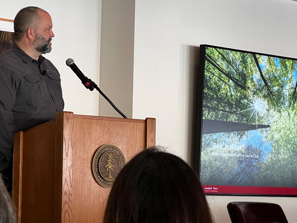 Ben Jealous speaking at a podium at Stanford 