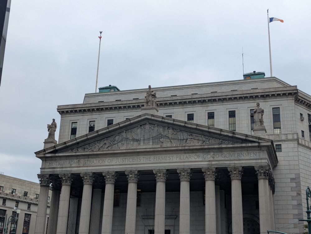 Engraving above NYC courthouse entrance which reads "the true administration of justice is the firmest pillar of good government" 