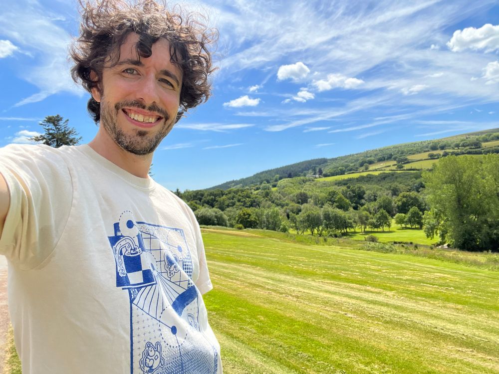 A wonderful, handsome, clever man wearing a beautiful Dyebreaker t-shirt in front of a charming british countryside