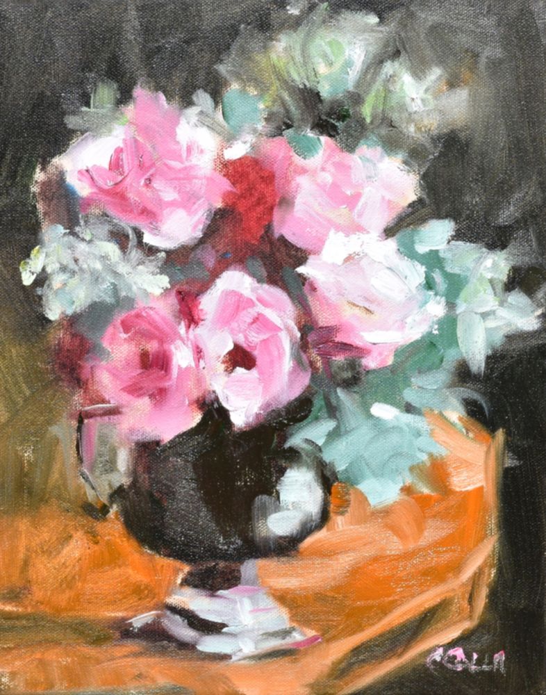This is an oil painting of a dark bronze vase sitting on an oak table. The vase holds a bouquet of pink roses with green leaves.
