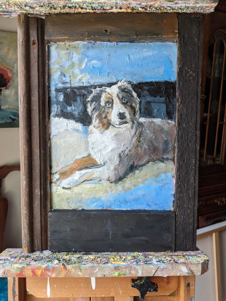 Oil portrait of a grey, brown and white dog. The painting is framed in old brown barn wood.