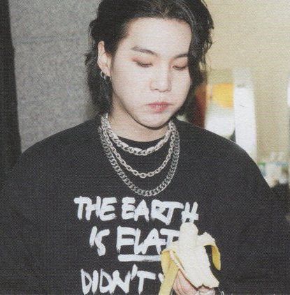 YTC busan yoongi wearing his black vetements “the earth is flat. didn’t you know that?” longleeeve and eating a banana