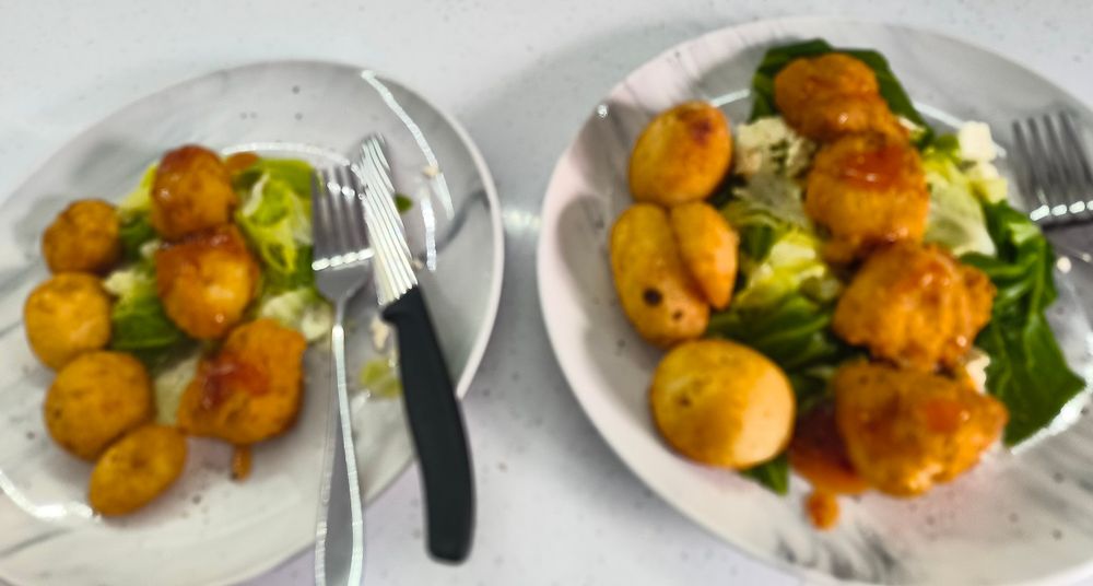 Apologies for awful photo. Essential tremor makes my hands shake. Crispy battered chicken balls with Thai sweet chilli sauce on a bed of boiled spring greens/collard greens with feta cheese. Beef dripping roast potatoes.
