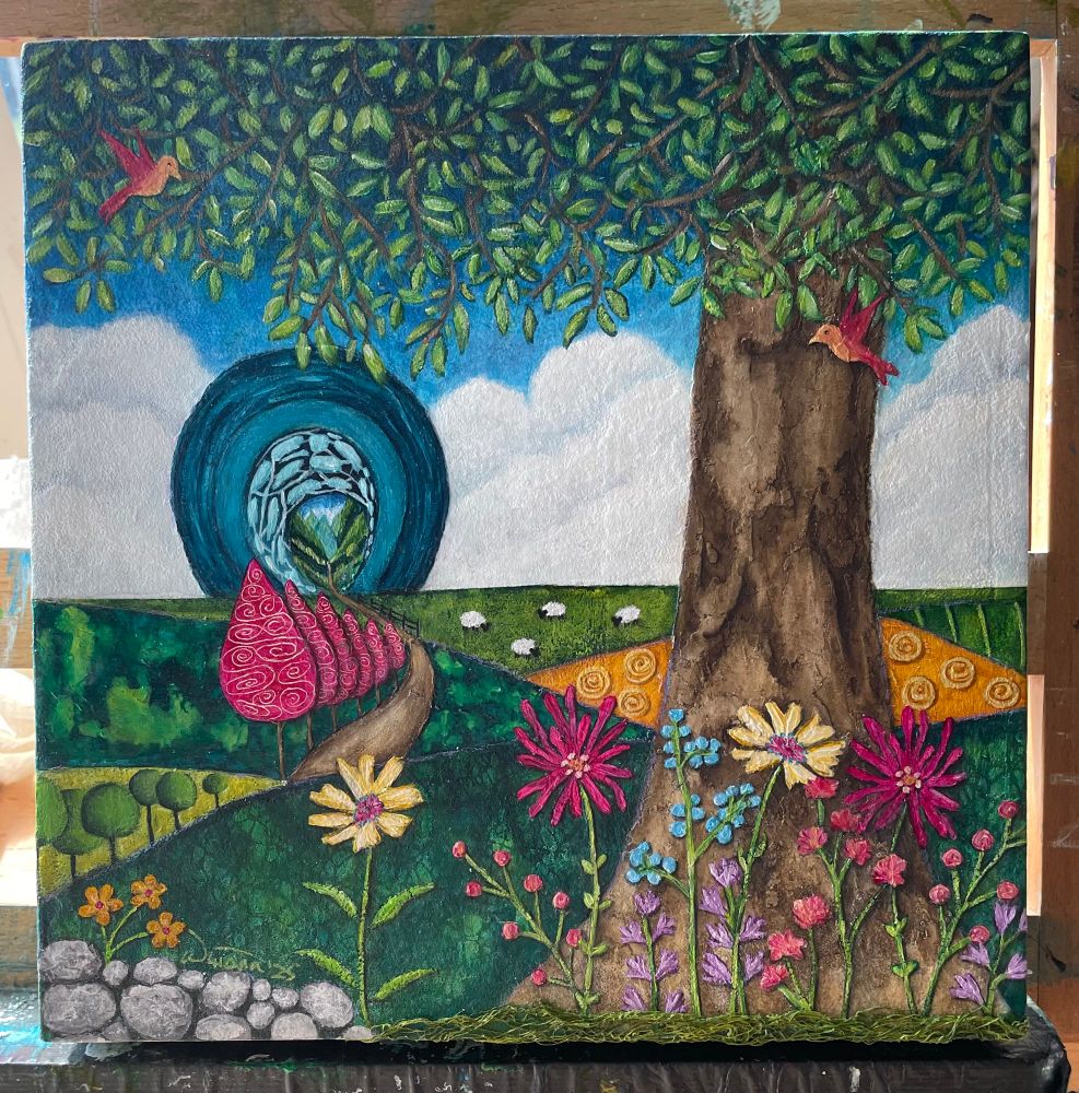 Painting of a fantasy landscape.
A large tree with a large leafy canopy stands on a hill in front of fields in the distance. Sheep graze on one, hay bales dot another, while a crop of small green trees occupy another. A row of magenta trees grow into the distance along a dirt path leading to the portal. There is a bank of large fluffy white clouds surrounding the teal coloured portal, through which is a land of giant mountains. There are various multicoloured flowers in the foreground and a pile of gray rocks to the left. Two little magenta and peach coloured birds fly near the big tree. Dyed green cheesecloth mimics grass at the tree base. 
"The Gate" acrylic and mixed media on cradle board. 8x8