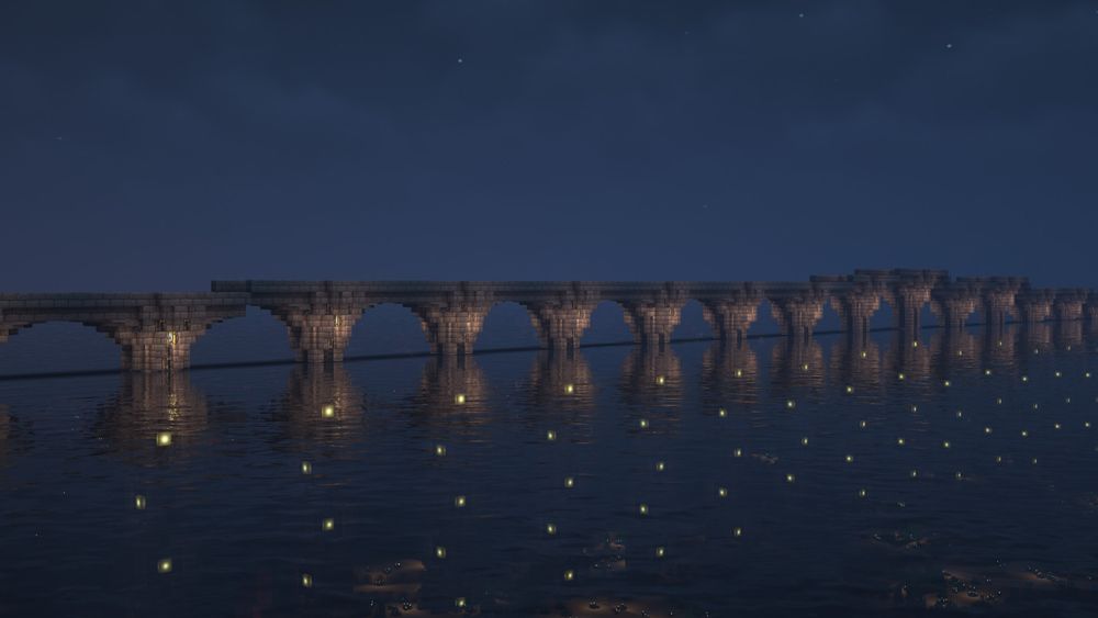 A minecraft screenhot with a bridge made of stone in the middle of the ocean.  Parts of the bridge go up and down.  Light blocks are visible in the water.
